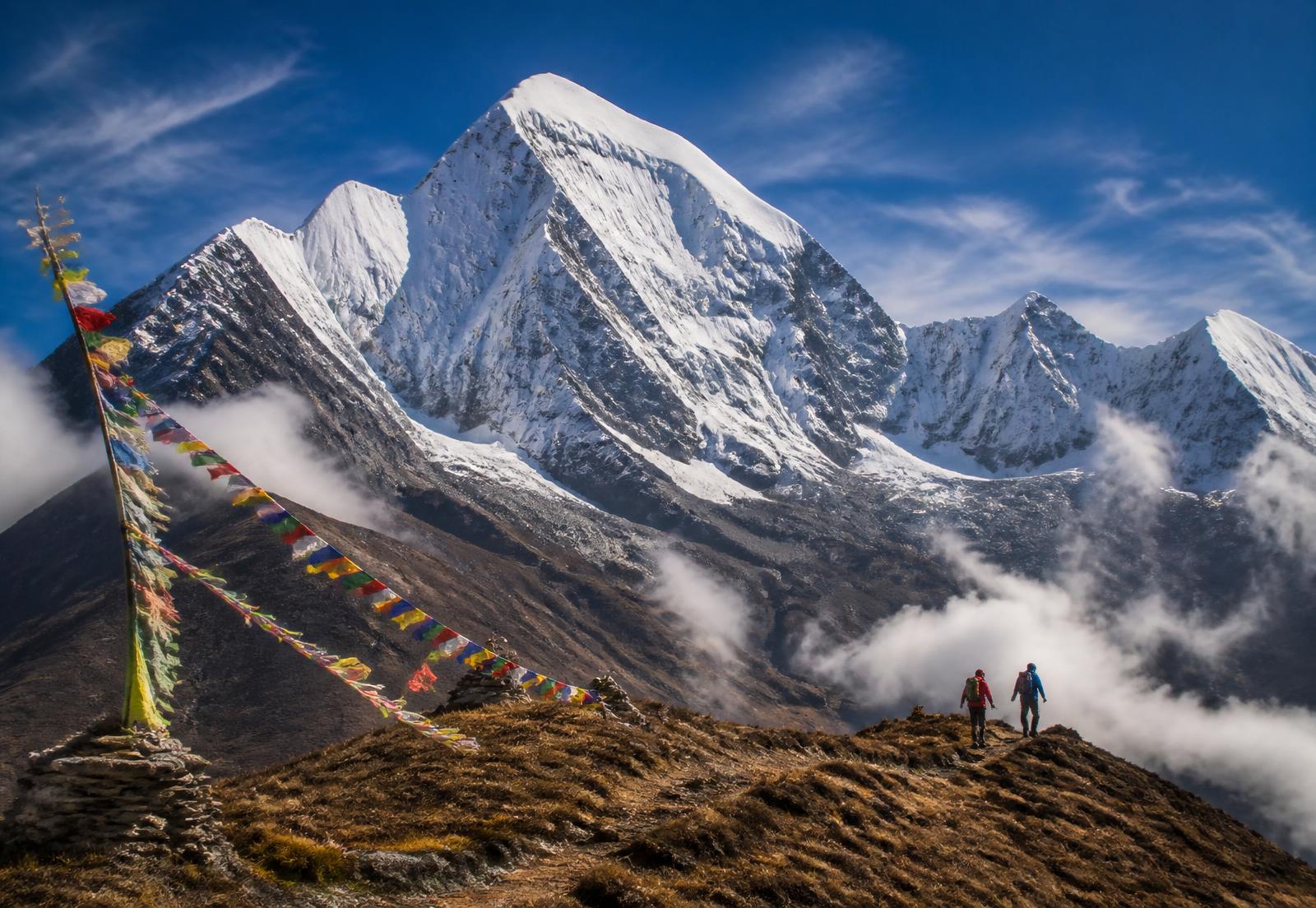 Trekkers crossing a high Himalayan ridge in Bhutan
