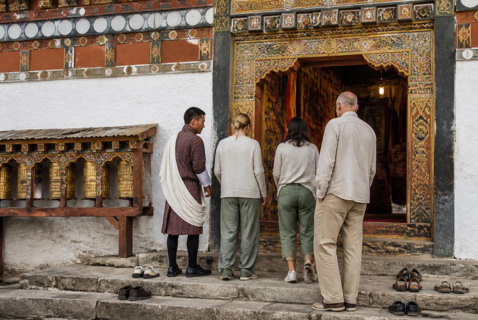 Visitors respectfully entering a Bhutanese monastery